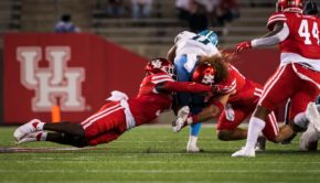 Senior linebacker Grant Stuard joins a teammate in bringing down a Tulane player during the 2020 opener at TDECU Stadium | Courtesy of UH athletics