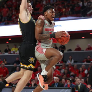 UH guard Marcus Sasser goes for the layup and battles through contact from a Wichita State defender in a game at Fertitta Center during the 2019-20 season. In Saturday's game against UCF, Sasser led UH in points. | Mikol Kindle Jr./The Cougar