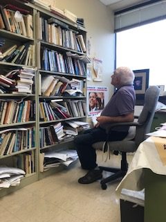 Murray looking over his work in his office. | Courtesy of Deborah Hartman