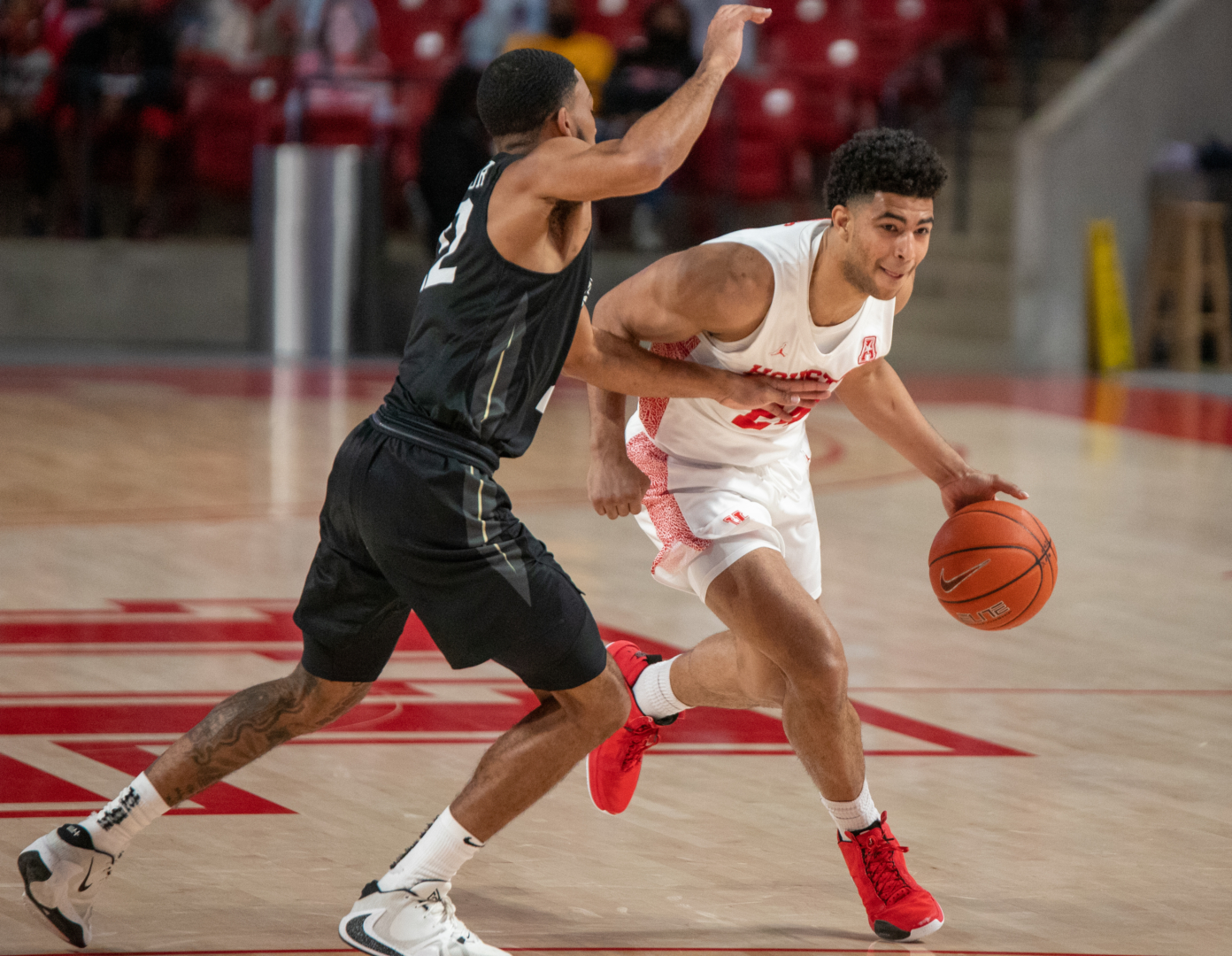 UH guard Quentin Grimes drives past a UCF defender on Jan. 17 inside of Fertitta Center. No. 8 UH had its game against Cincinnati postponed. | Andy Yanez/The Cougar