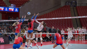 UH volleyball middle blocker Rachel Tullos (11), who had 10 kills in the fire match against Stephen F. Austin on Thursday, greets SMU players at the top of the net in a regular season game against the Mustangs in the 2019 season. | Trevor Nolley/The Cougar