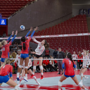 UH volleyball middle blocker Rachel Tullos (11), who had 10 kills in the fire match against Stephen F. Austin on Thursday, greets SMU players at the top of the net in a regular season game against the Mustangs in the 2019 season. | Trevor Nolley/The Cougar