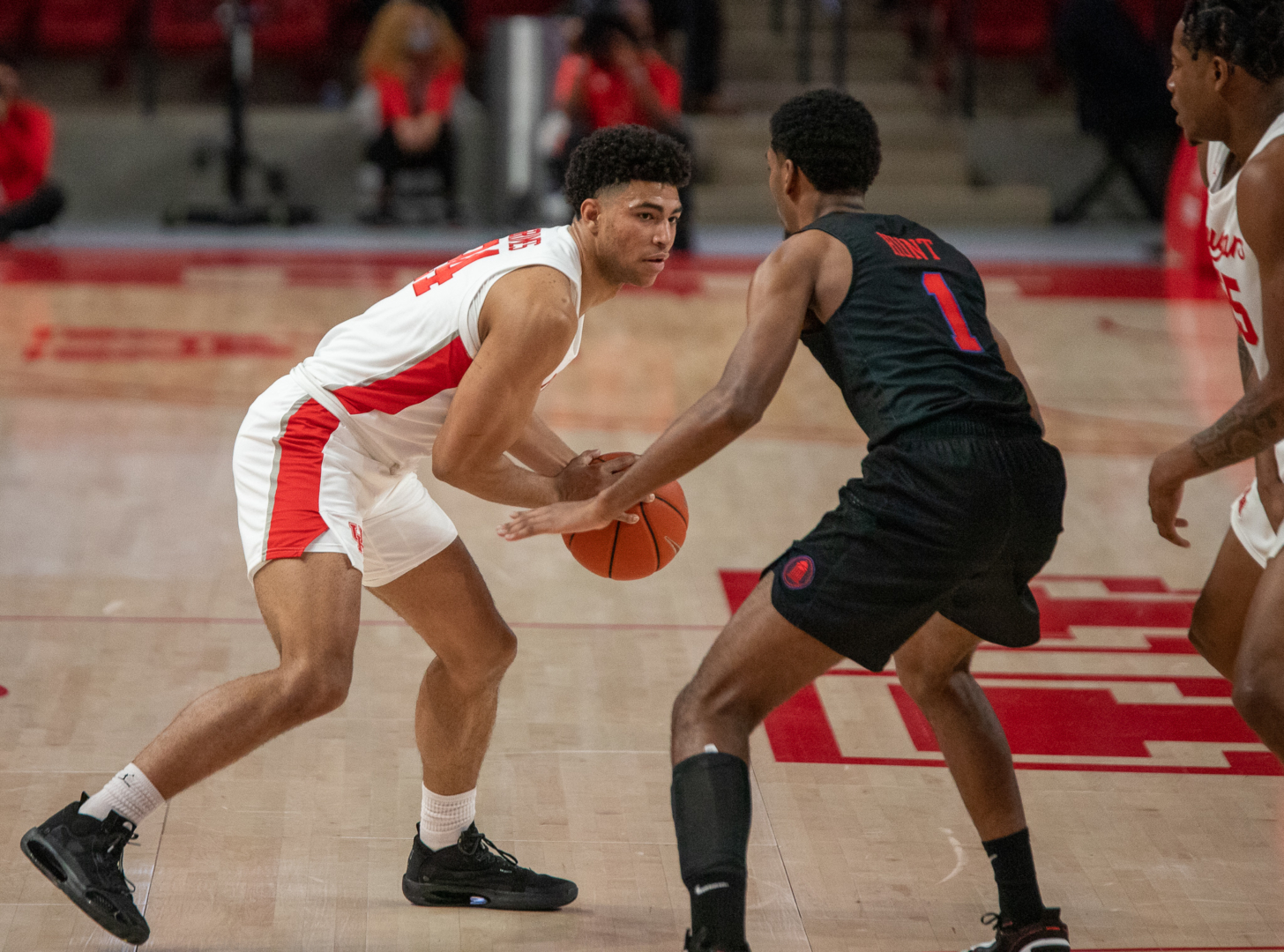 UH guard Quentin Grimes holds the ball with an SMU defender in front of him during a game in the 2020-21 season at Fertitta Center. The UH men's basketball team was announced as a two-seed in the NCAA's in-season bracket show on Saturday. | Andy Yanez/The Cougar