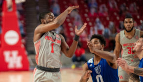 Houston freshman guard Jamal Shead (1) dishes out a pass to a teammate in a game against Our Lady of the Lake at the Fertitta Center. | Andy Yanez/The Cougar