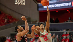 UH men's basketball guard Tramon Mark (12) eases his way around Western Kentucky center Charles Bassey for the layup on Feb. 25 at Fertitta Center. UH will host USF on Sunday. | Andy Yanez/The Cougar