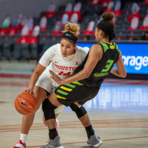 UH women's basketball guard Laila Blair crashes into USF guard Sydni Harvey during Saturday's game at Fertitta Center. | Andy Yanez/The Cougar