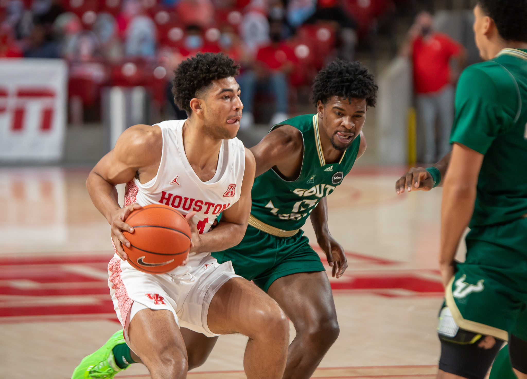 UH men's basketball guard Quentin Grimes (24) drives past USF senior guard Justin Brown during Sunday's game at Fertitta Center. | Andy Yanez/The Cougar