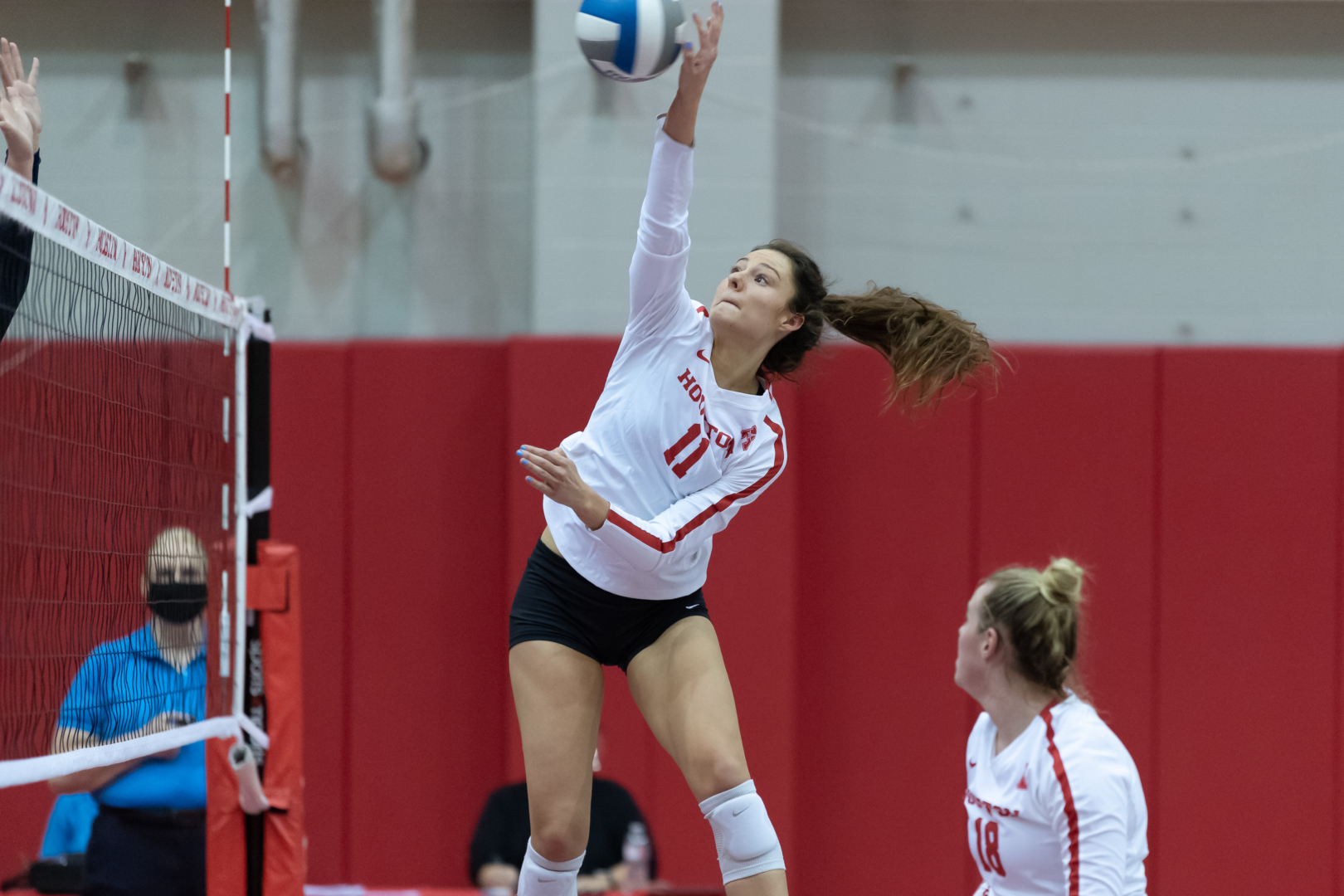 UH volleyball sophomore middle blocker Rachel Tullos extends high for the ball in a game against Rice during the 2020-21 season. | Courtesy of UH athletics