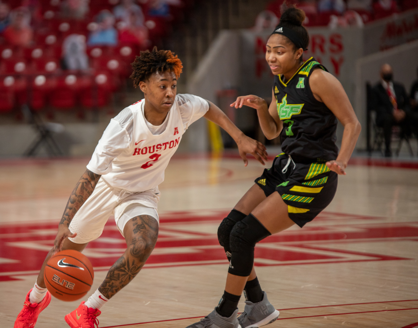 UH women's basketball guard Miya Crump (2) drives past a USF defender on Feb. 27 inside of Fertitta Center. Crump tied an AAC-record with six steals on Tuesday during the UH women's basketball team's game against ECU. | Andy Yanez/The Cougar