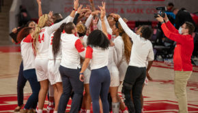 The UH women's basketball team coaches and players come together at the half-court line and celebrate their win over No. 13 USF. | Andy Yanez/The Cougar