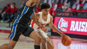 UH junior guard Quentin Grimes dribbles with his left hand as he is draped by a Memphis defender during a game on March 7 at Fertitta Center. | Andy Yanez/The Cougar