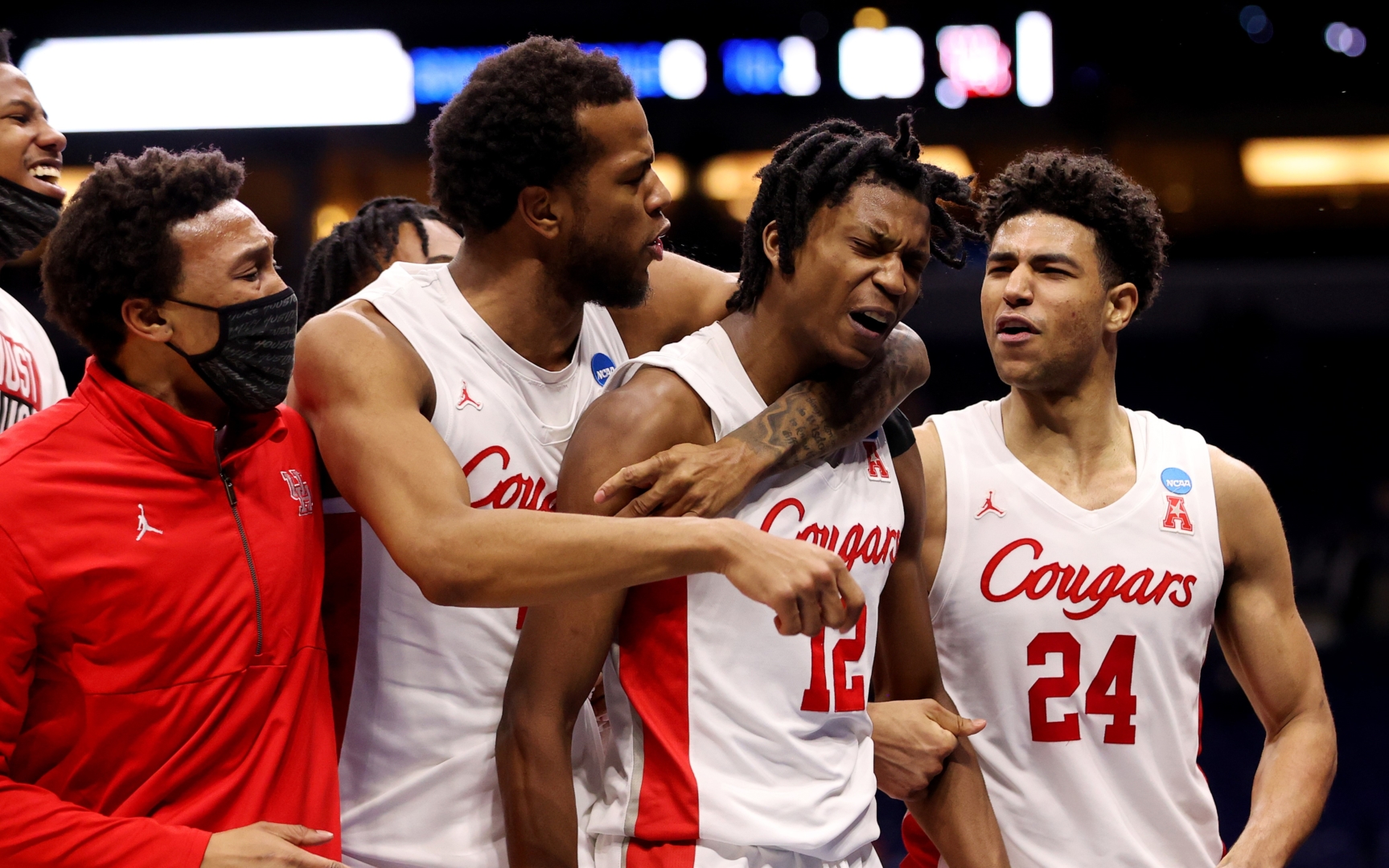Justin Gorham (left) and Quentin Grimes (right) celebrate around freshman Tramon Mark (middle) after the Cougars' last-minute comeback win over Rutgers in the round of 32 in the NCAA Tournament at Lucas Oil Stadium on March 21, 2021 in Indianapolis, Indiana. | Photo by Jamie Schwaberow/NCAA Photos via Getty Images