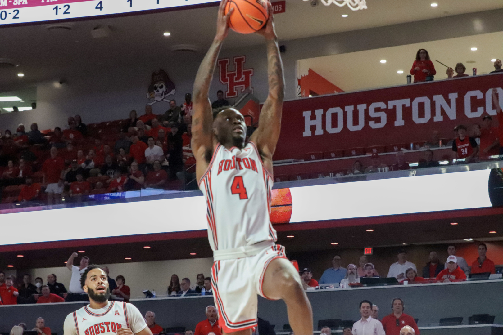 Senior guard Taze Moore takes flight for a two-handed slam during the first half of UH basketball's win over Temple on Thursday night at Fertitta Center. | Armando Yanez/The Cougar