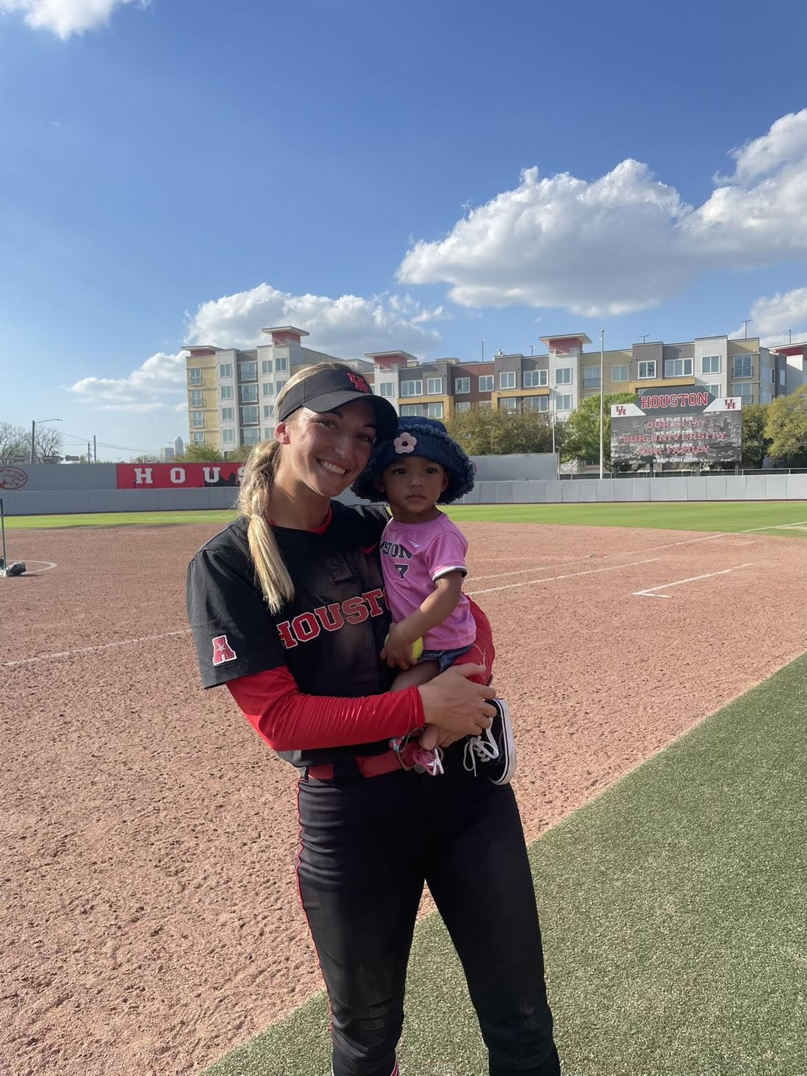 Becca Schulte celebrates a UH softball walk off win the best way she knows how — with her daughter. | Courtesy of Becca Schulte