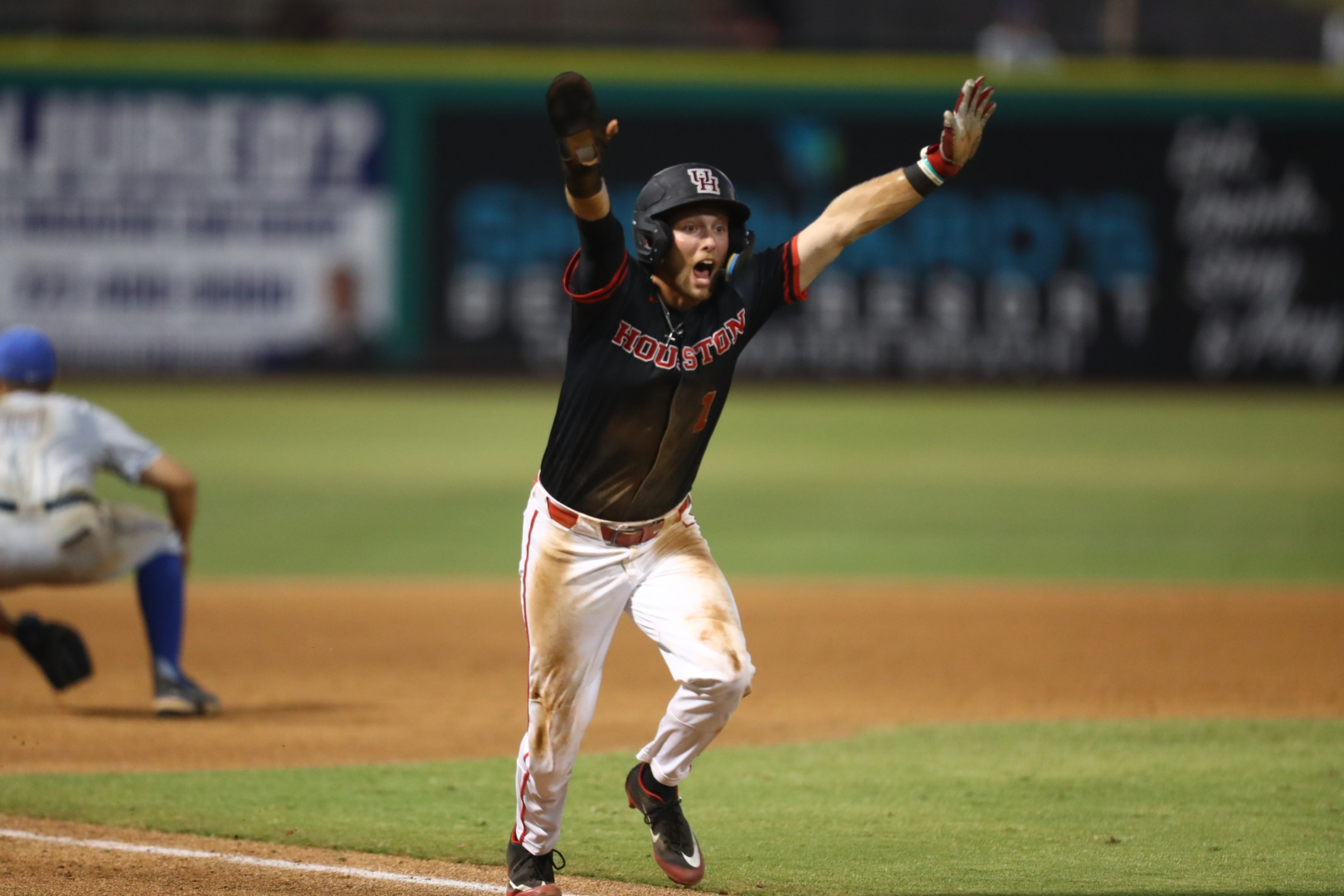 Brandon Burckel throws his arms in the air as he scores the winning run for UH baseball in the Cougars' walk-off victory over Memphis on Thursday evening at the AAC tournament in Clearwater, Florida. | American Athletic Conference/Mary Holt