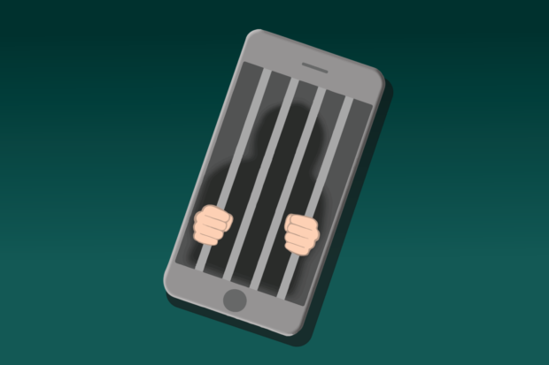 A telephone depicting a prison cell with hands holding the bars in a fist