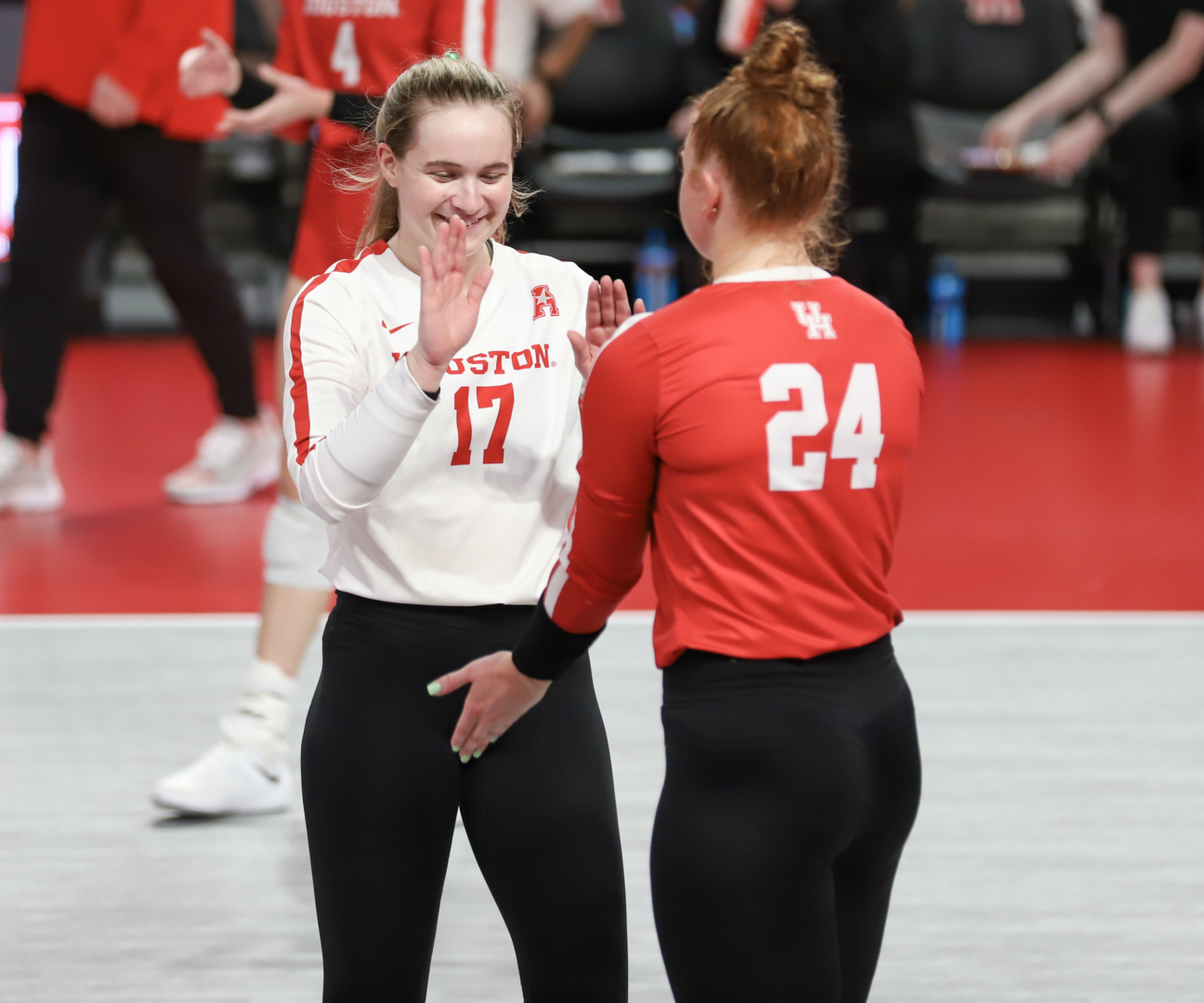 Kate Georgiades high fives UH volleyball outside hitter Abbie Jackson after winning a point during the Cougars match against USF on Oct. 9 at Fertitta Center. | James Mueller