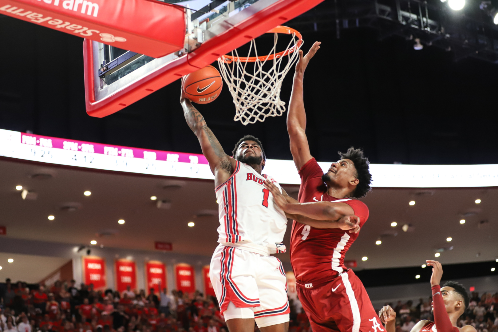 UH point guard Jamal Shead put Alabama's Noah Gurley on a poster with a one-handed slam in the first half of Saturday afternoon's game. | Sean Thomas/The Cougar
