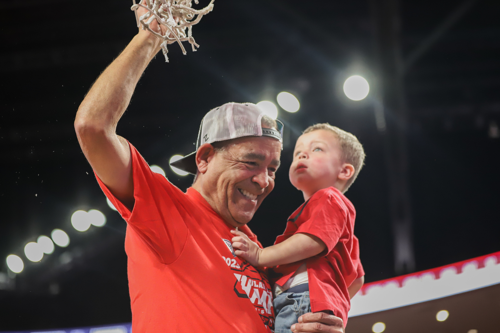 Holding his grandson Kylen, Kelvin Sampson was all smiles after cutting down his seventh net as the UH head coach after the top-ranked Cougars' win over Wichita State on Thursday night. | Anh Le/The Cougar
