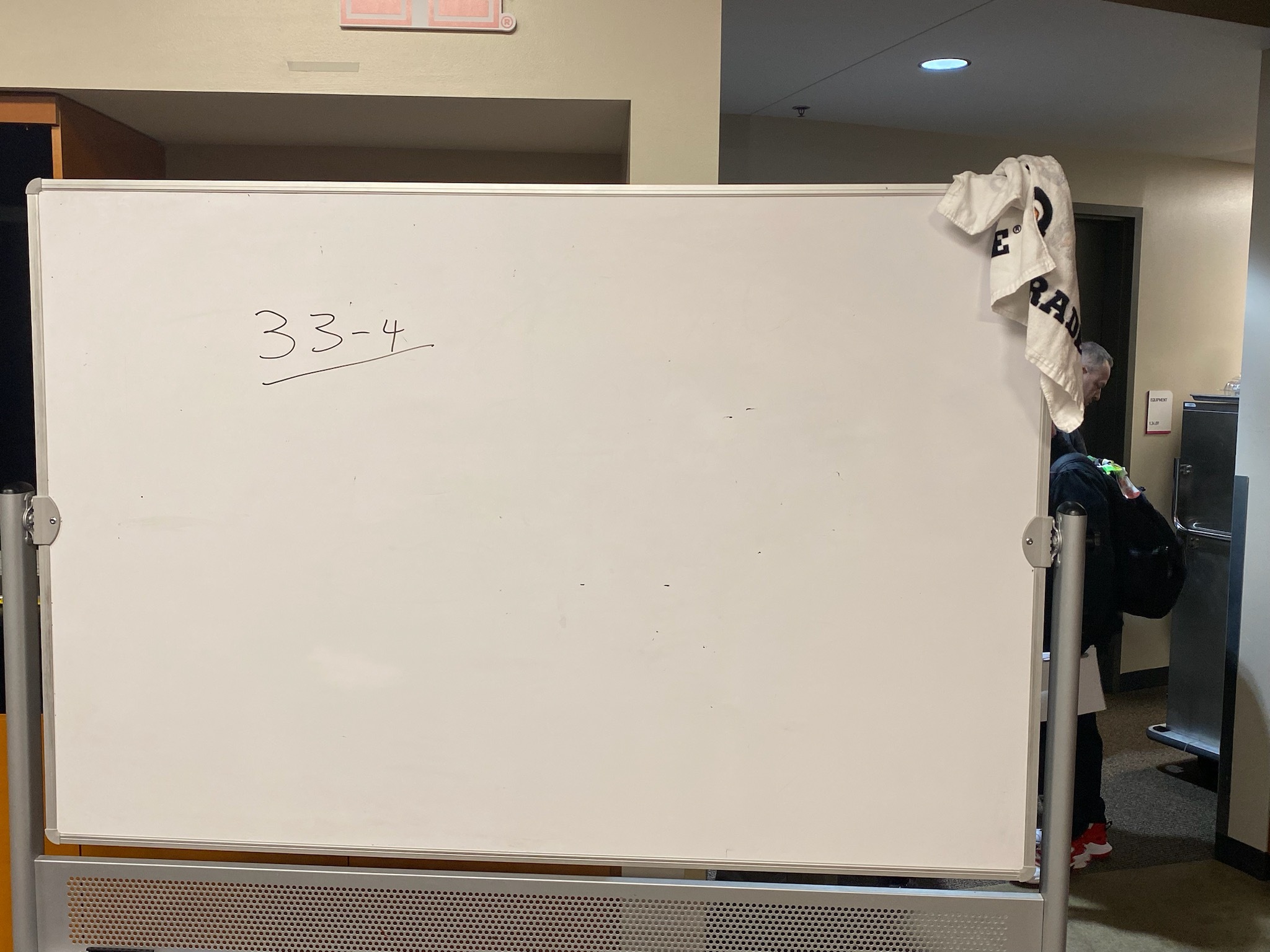 Kelvin Sampson wrote 33-4, UH's record to end the 2022-23 season, on the whiteboard in the Cougars' locker room following the loss to Miami in the Sweet 16 on Friday night. | James Mueller/The Cougar